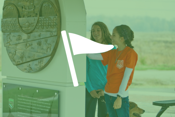 two young girls enjoying art at a trailhead